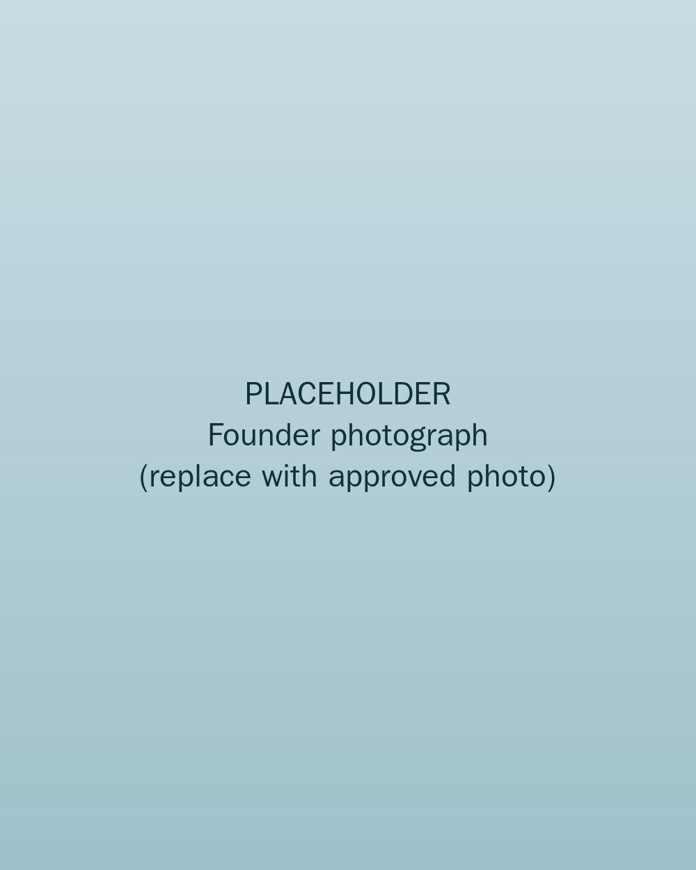 A thoughtful founder reflecting on a family photograph